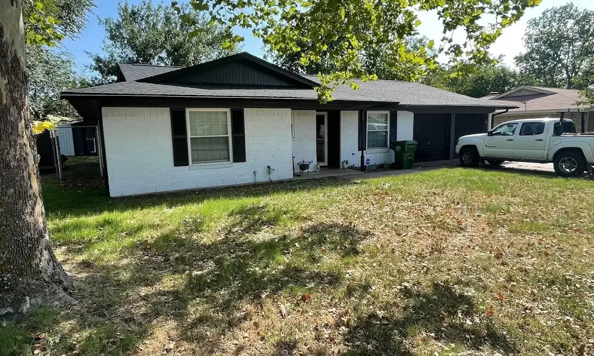 Professional roofing crew working on a residential roof in Waianae